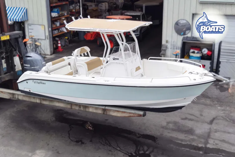 Slide: The Image of 2021 Edgewater 208CC boat with Yamaha engine, displayed in a workshop setting. - 0