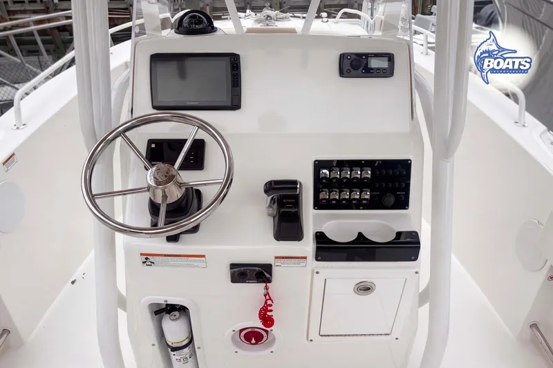 Slide: The Image of Edgewater 208CC 2021 boat console with steering wheel, navigation screen, and control panel. - 7