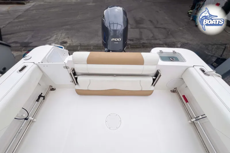Slide: The Image of 2021 Edgewater 208CC boat interior with seating and outboard motor. - 8