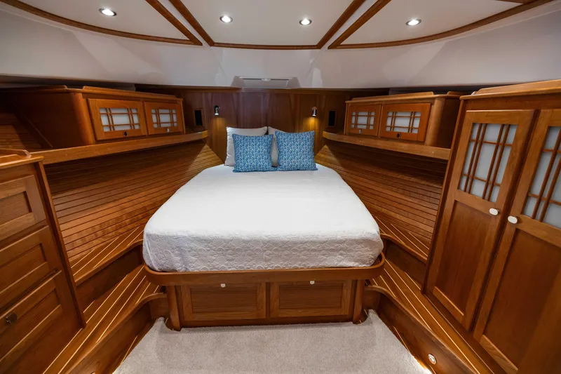 Slide: The Image of Luxurious 2026 Sabre 58 Salon Express cabin with elegant wood finish and cozy bedding. - 24