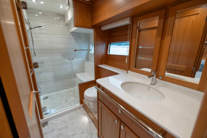 Slide: The Image of Luxurious bathroom in 2026 Sabre 58 Salon Express yacht with modern fixtures and wooden cabinetry. - 21