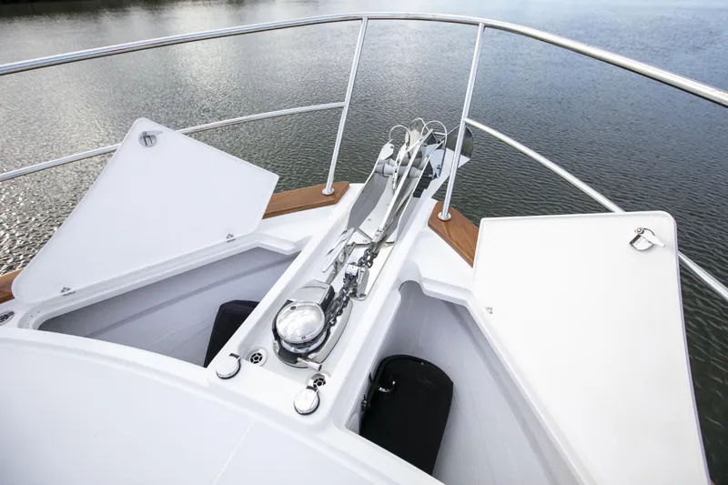 Slide: The Image of Bow of 2026 Sabre 58 Salon Express yacht with anchor system, on calm water. - 36
