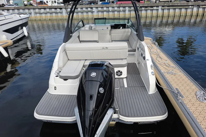 Slide: The Image of 2024 Sea Ray SDX 250 boat docked, showcasing sleek design and spacious seating. - 8