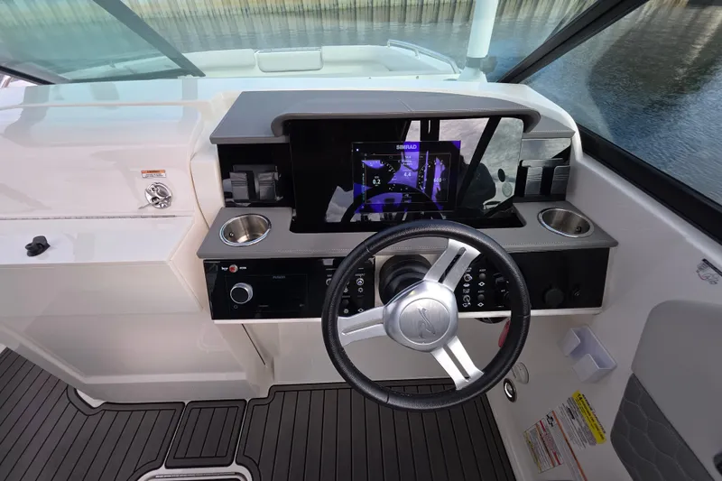 Slide: The Image of 2024 Sea Ray SDX 250 helm with modern controls and navigation display. - 14