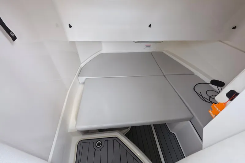 Slide: The Image of 2024 Sea Ray SDX 250 cabin interior with cushioned seating and modern design. - 12
