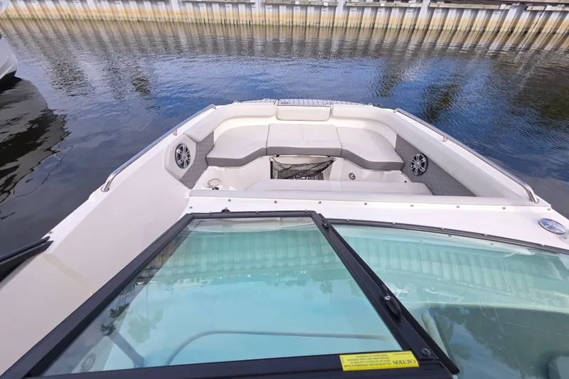 Slide: The Image of 2024 Sea Ray SDX 250 boat interior with spacious seating and waterfront view. - 9