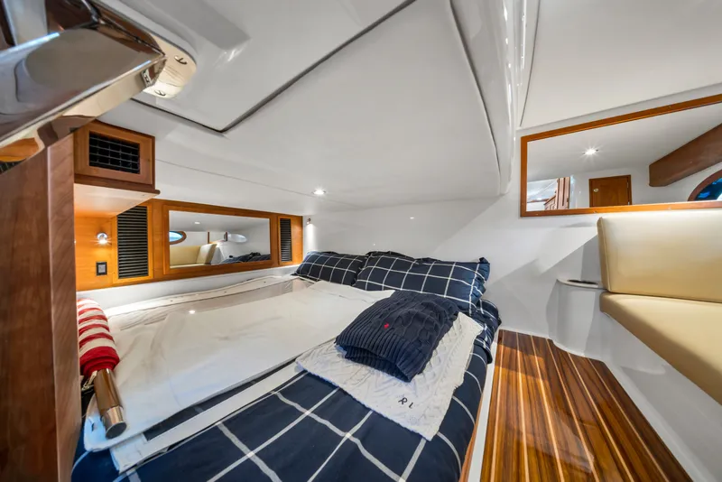 Slide: The Image of Luxurious cabin interior of 2023 Hinckley Sport Boat 40 X with cozy bedding. - 16