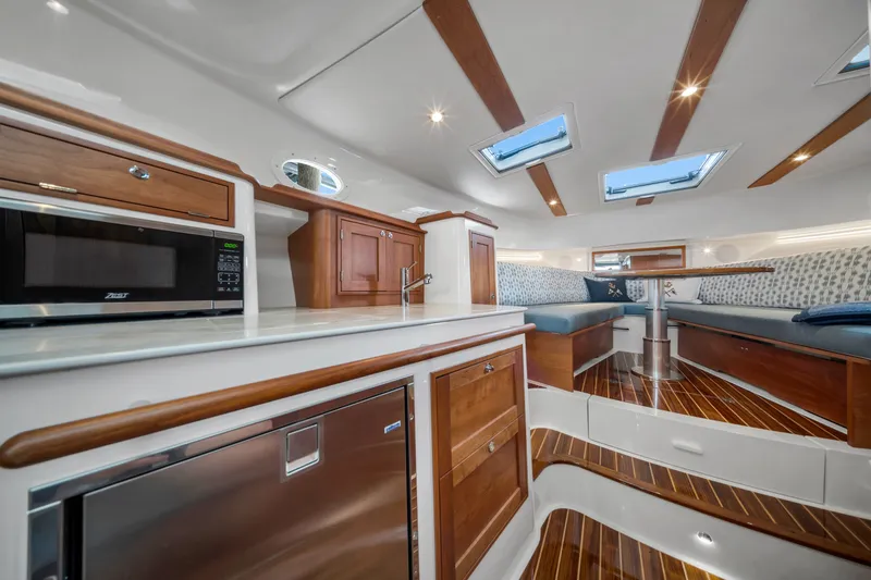 Slide: The Image of Luxurious interior of 2023 Hinckley Sport Boat 40 X with modern kitchen and seating area. - 13