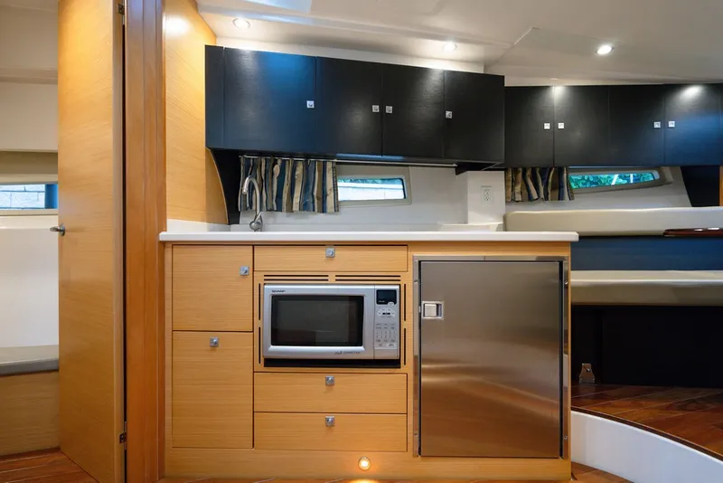 Slide: The Image of The interior view shows a well-equipped kitchen with a microwave and refrigerator. - 43