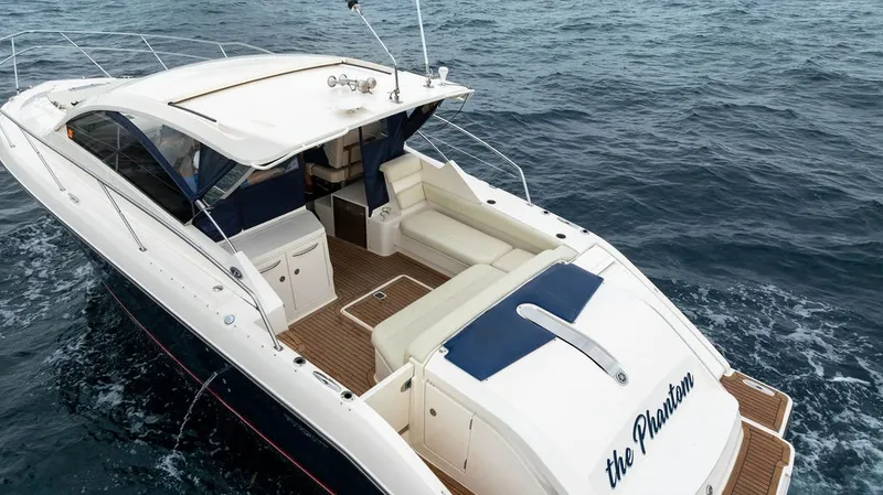 Slide: The Image of The 2013 Pursuit SC 365i Sport Coupe is cruising on open water. It features a sleek design with a spacious cockpit and comfortable seating. - 28