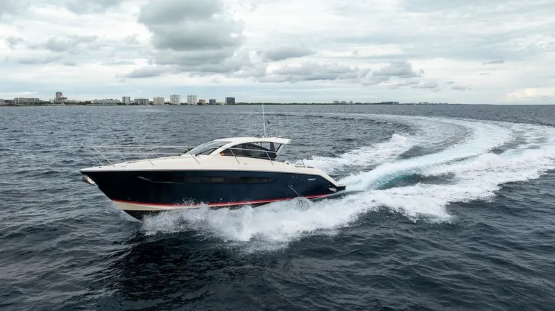 Slide: The Image of A 2013 Pursuit SC 365i Sport Coupe speeds across the sea under a cloudy sky. - 24