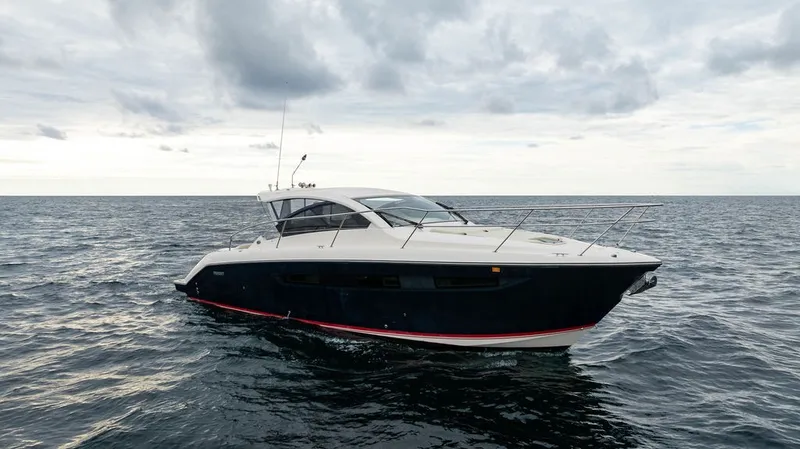 Slide: The Image of A 2013 Pursuit SC 365i Sport Coupe on open water under a cloudy sky. - 32