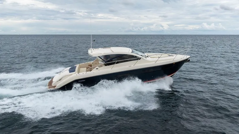 Slide: The Image of A 2013 Pursuit SC 365i Sport Coupe speeds across the ocean, surrounded by waves. - 13