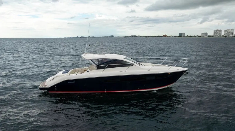 Slide: The Image of A 2013 Pursuit SC 365i Sport Coupe on the water, featuring sleek design and spacious deck. - 31