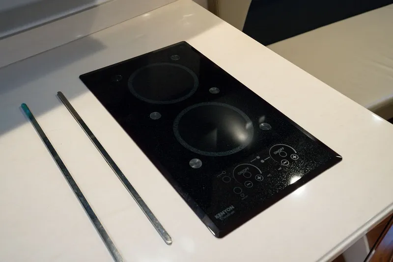 Slide: The Image of A modern cooktop with two burners on a sleek, white surface. - 45