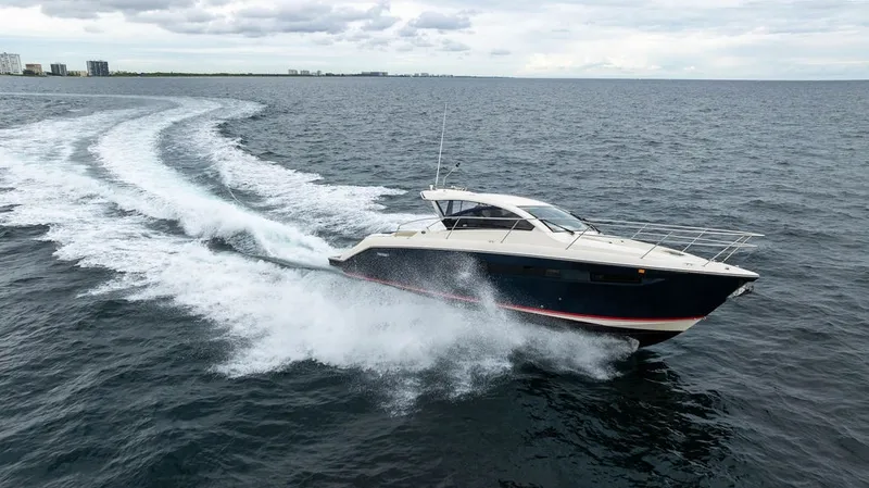 Slide: The Image of A 2013 Pursuit SC 365i Sport Coupe speeds across the water, surrounded by waves. - 22
