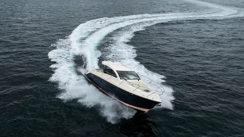 Slide: The Image of A 2013 Pursuit SC 365i Sport Coupe speeds across the water, leaving a white wake. - 16