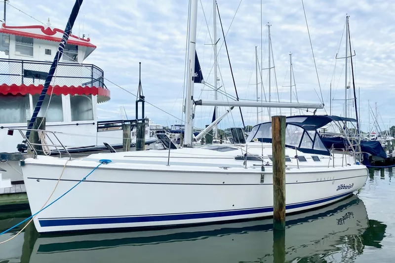 Slide: The Image of 2008 Hunter 41 Aft Cockpit sailboat docked in a marina, surrounded by other boats. - 37