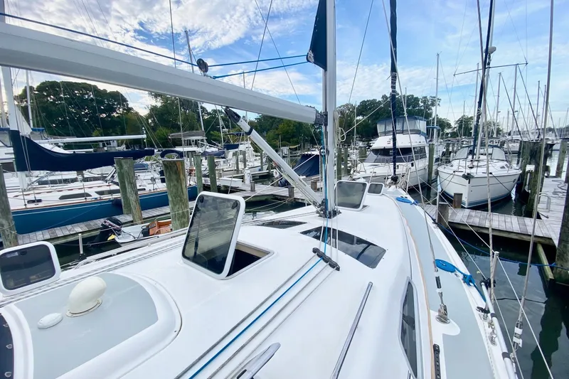 Slide: The Image of 2008 Hunter 41 Aft Cockpit sailboat docked at marina under blue sky. - 43