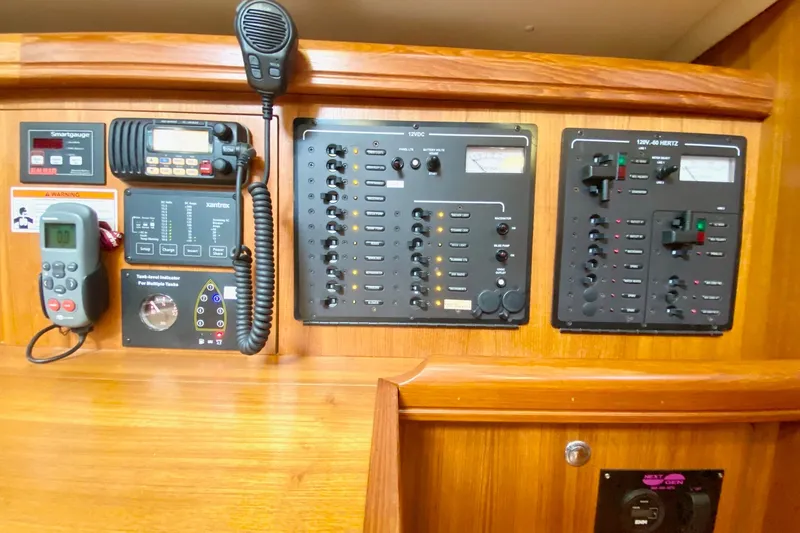Slide: The Image of Control panel of a 2008 Hunter 41 Aft Cockpit sailboat with various gauges and switches. - 35