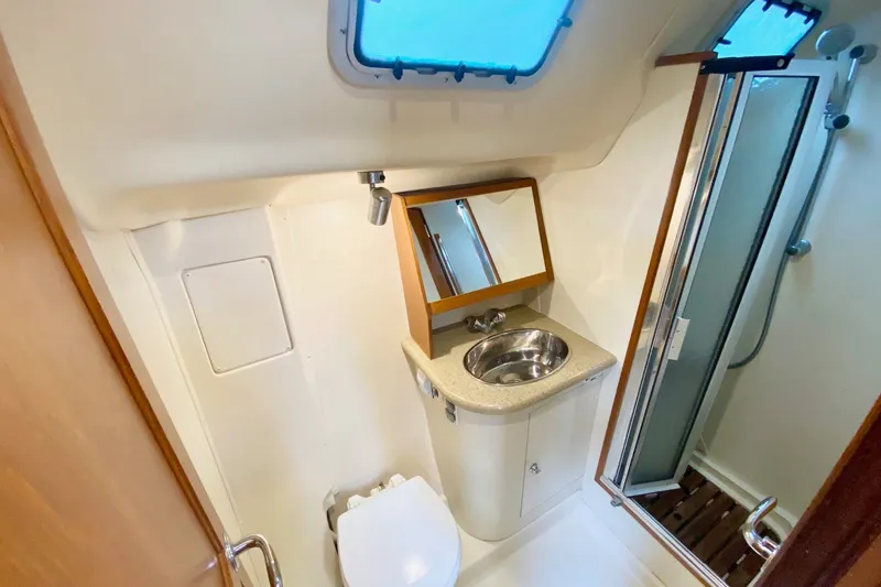 Slide: The Image of 2008 Hunter 41 Aft Cockpit bathroom with sink, mirror, and shower. - 26