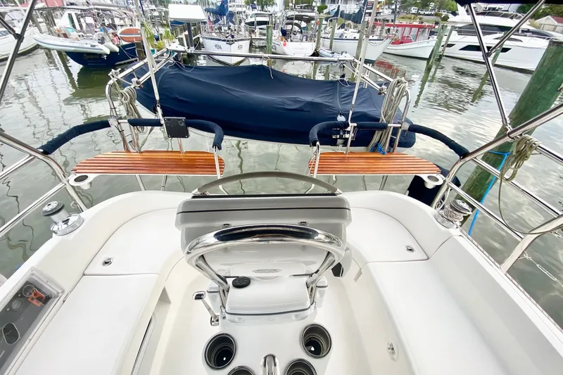Slide: The Image of 2008 Hunter 41 Aft Cockpit sailboat with polished helm and wooden seating at marina. - 49