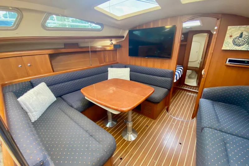 Slide: The Image of Luxurious interior of 2008 Hunter 41 Aft Cockpit yacht with cozy seating and wooden finishes. - 14