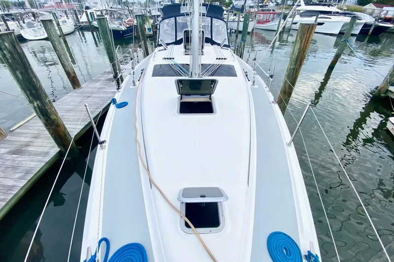 Slide: The Image of 2008 Hunter 41 Aft Cockpit sailboat docked at marina, showcasing deck and rigging. - 39