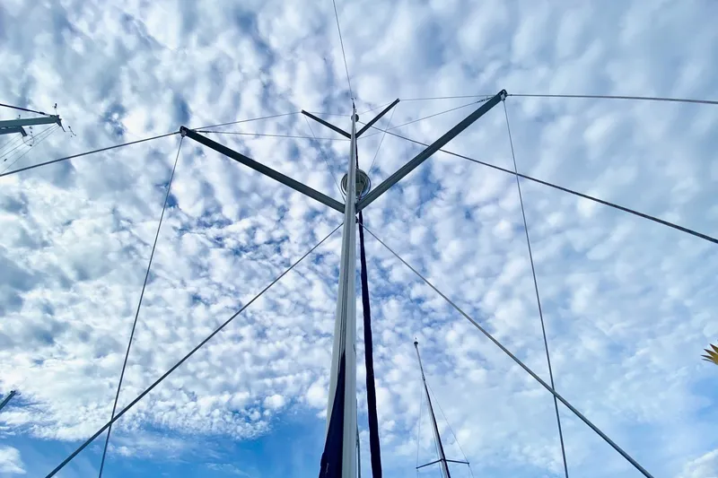 Slide: The Image of Mast of 2008 Hunter 41 Aft Cockpit sailboat against a cloudy sky. - 46