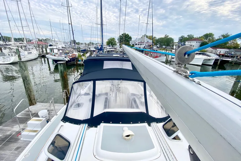 Slide: The Image of 2008 Hunter 41 Aft Cockpit sailboat docked at a marina, surrounded by other boats. - 47