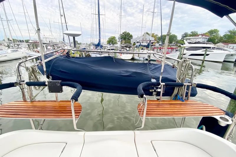 Slide: The Image of Hunter 41 Aft Cockpit 2008 sailboat docked at marina with wooden seats. - 50