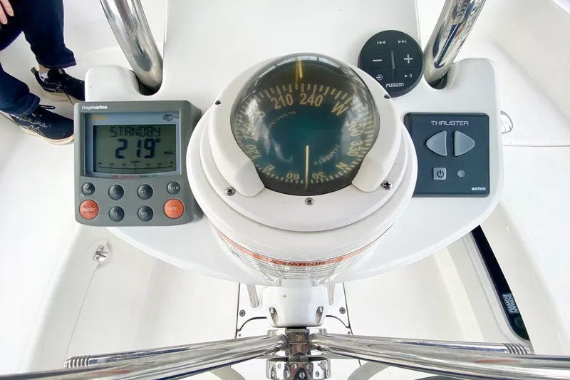 Slide: The Image of Cockpit controls of 2008 Hunter 41 Aft Cockpit sailboat with compass and navigation instruments. - 54