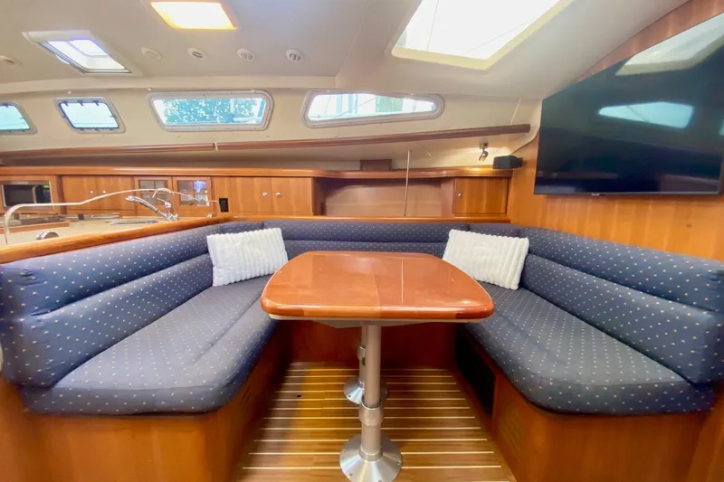 Slide: The Image of Interior of 2008 Hunter 41 Aft Cockpit yacht with cozy seating and wooden table. - 17