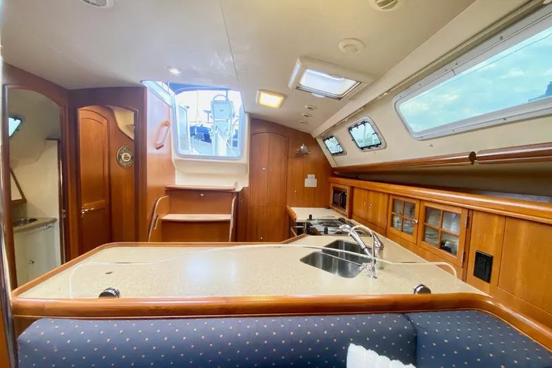 Slide: The Image of Interior of 2008 Hunter 41 Aft Cockpit sailboat with modern kitchen and wooden cabinetry. - 20