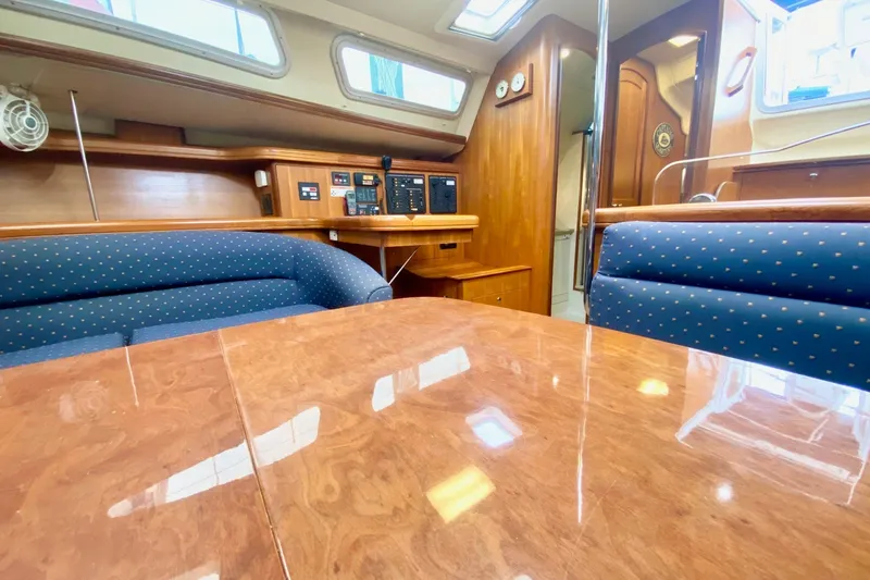 Slide: The Image of Interior of 2008 Hunter 41 Aft Cockpit yacht with wood finish and blue seating. - 19