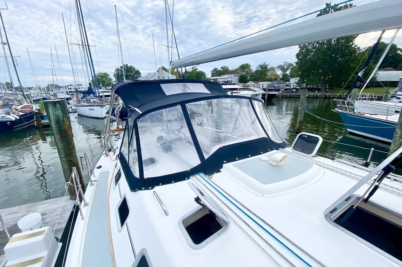 Slide: The Image of 2008 Hunter 41 Aft Cockpit sailboat docked at a marina, featuring a covered cockpit. - 42