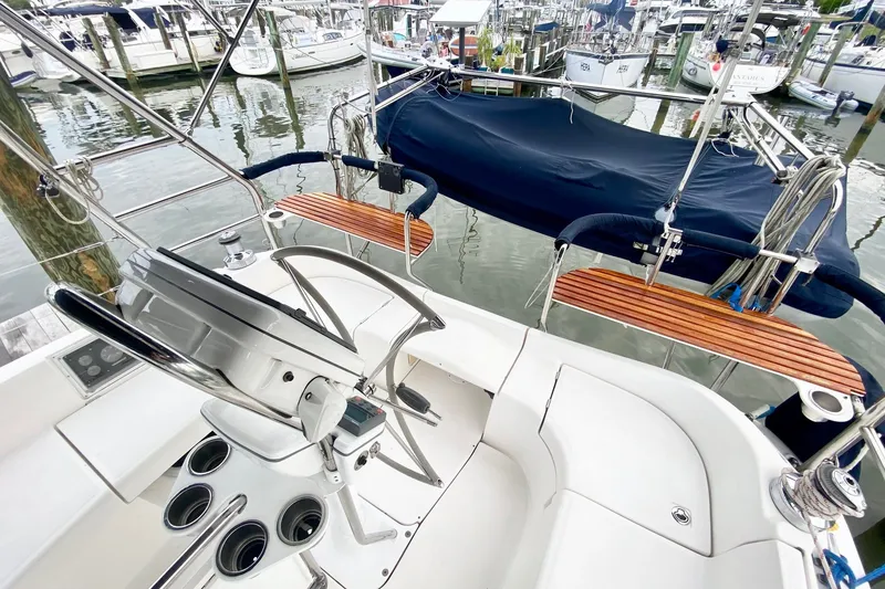 Slide: The Image of 2008 Hunter 41 Aft Cockpit sailboat helm with marina view. - 52