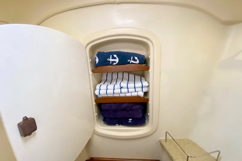 Slide: The Image of Storage cabinet with neatly folded towels inside a 2008 Hunter 41 Aft Cockpit yacht. - 32