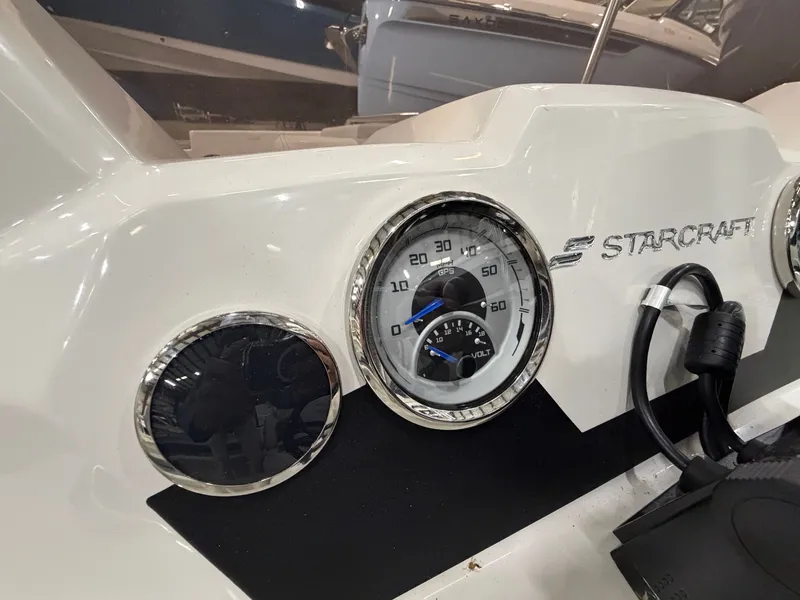 Slide: The Image of Close-up of a Starcraft SVX 171 OB dashboard with speedometer and logo. - 16