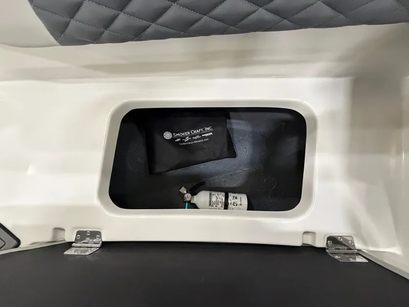 Slide: The Image of A storage compartment in the boat with a bag and a fire extinguisher. - 25