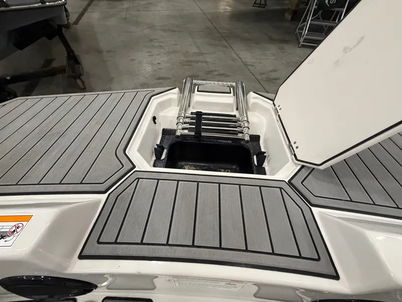 Slide: The Image of The image shows the stern of a Starcraft SVX 171 OB with a retractable swim ladder. - 22