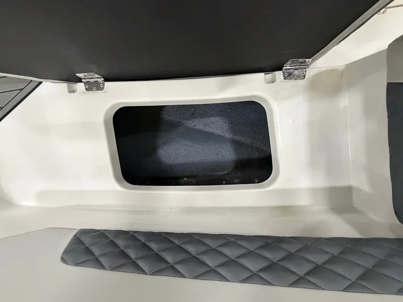 Slide: The Image of A storage compartment with padded seating and a hinged lid on a Starcraft boat. - 24