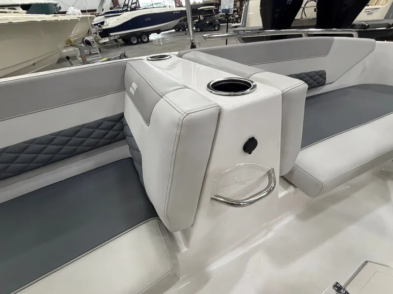 Slide: The Image of Interior view of a Starcraft SVX 171 OB with gray and white seating and cup holders. - 29