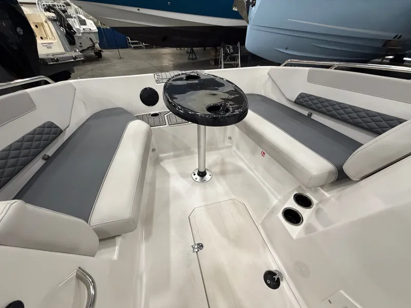 Slide: The Image of Interior view of a 2026 Starcraft SVX 171 OB with gray seating and a round table. - 19