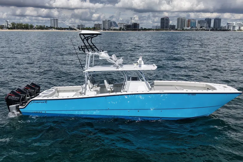 The Image of 2024 Freeman 42LR boat on water, city skyline in background, clear skies. - 0
