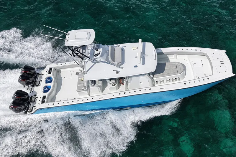 Slide: The Image of 2024 Freeman 42LR boat cruising on clear turquoise water, showcasing powerful engines. - 4