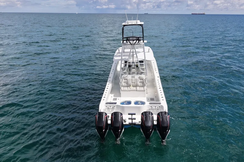 Slide: The Image of 2024 Freeman 42LR boat with four engines on open water. - 2