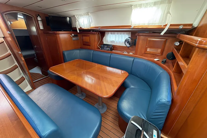 Slide: The Image of Luxurious interior of a 2001 Beneteau 50 yacht with wooden furnishings and blue seating. - 3