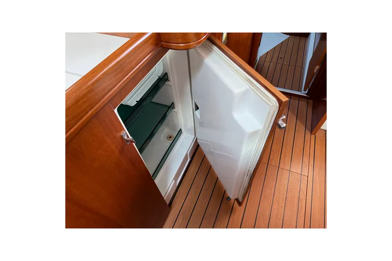 Slide: The Image of Open refrigerator on 2001 Beneteau 50 yacht with wooden flooring. - 18