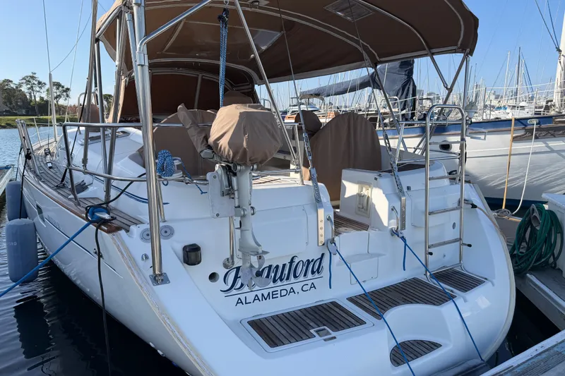 Slide: The Image of Beneteau 50 sailboat, 2001 model, docked in Alameda, CA, with covered seating and equipment. - 1